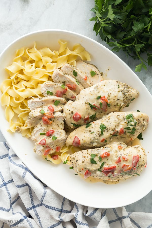 creamy italian instant pot chicken breast on a white platter with noodles