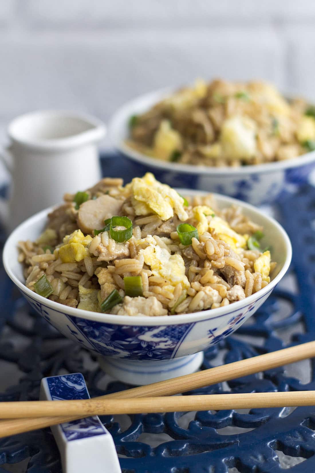 A bowl of low fat chicken fried rice topped with green onion